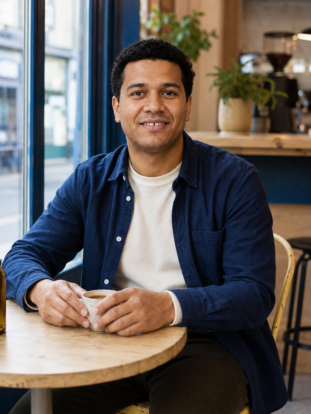 Dateframe character in an indigo overshirt at a neighbourhood café
